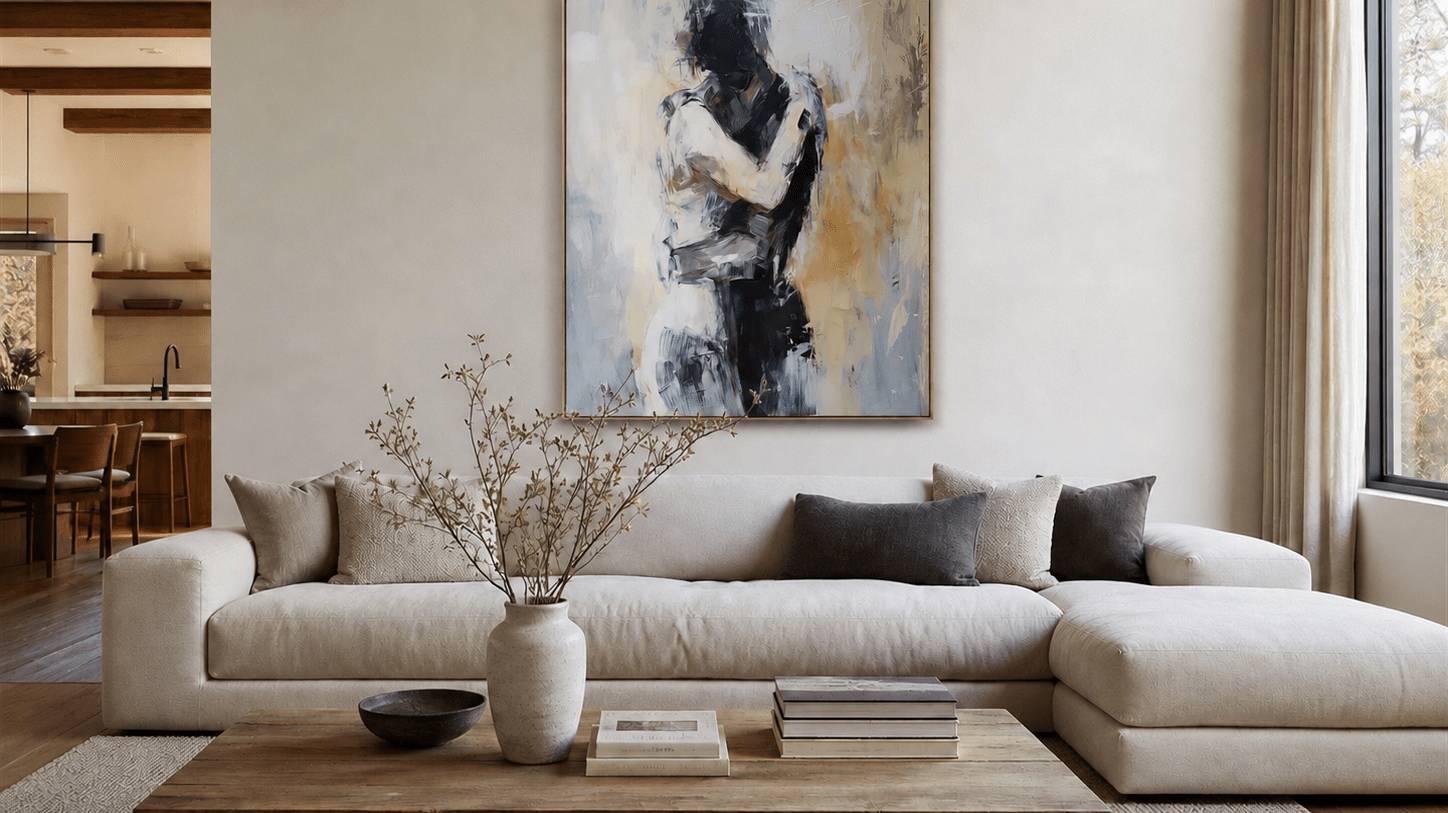 Abstract couple wall art above a white sectional in a neutral living room