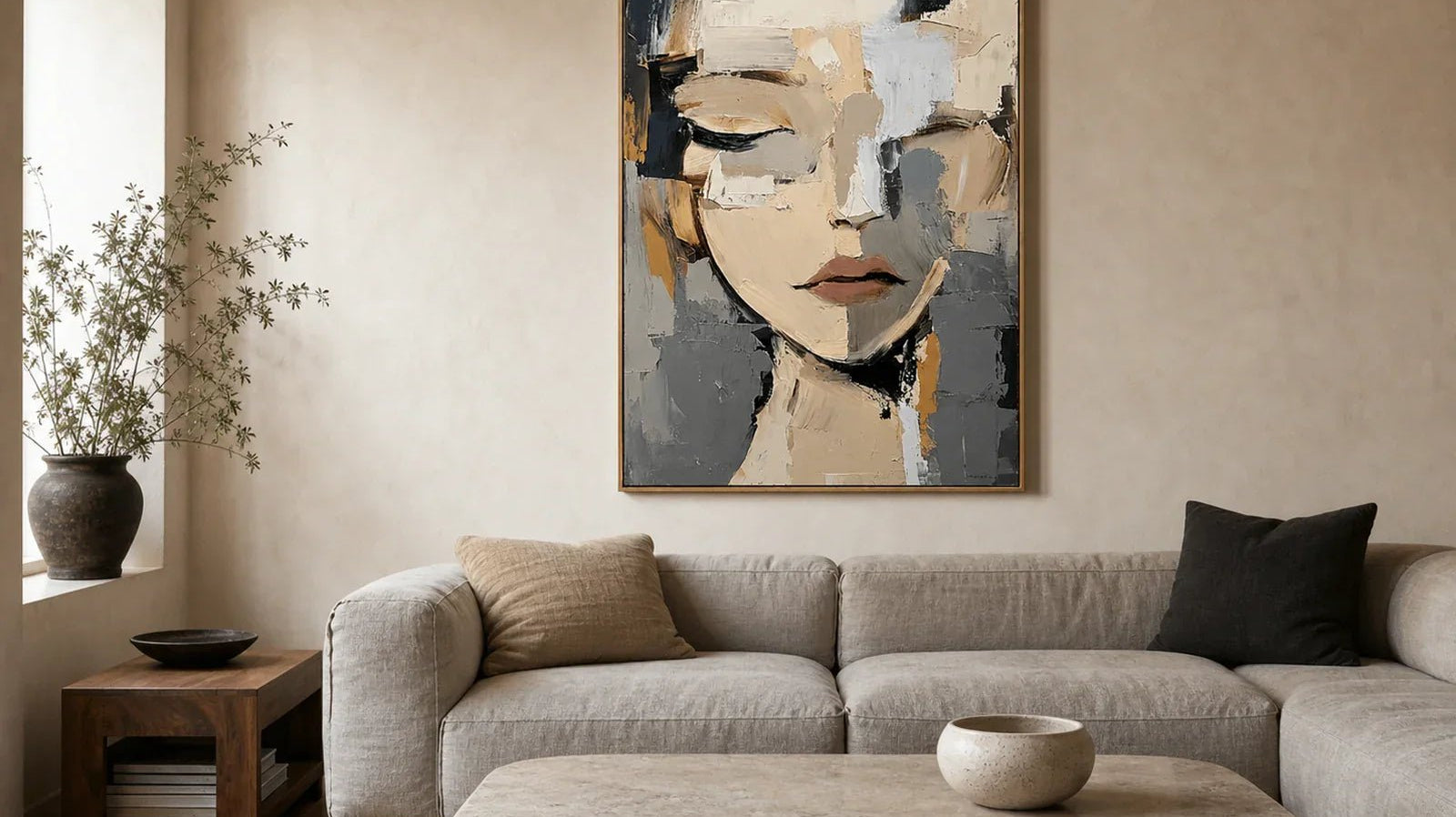 Hand-painted beige, gray and charcoal abstract face portrait above a linen sofa in a contemporary living room