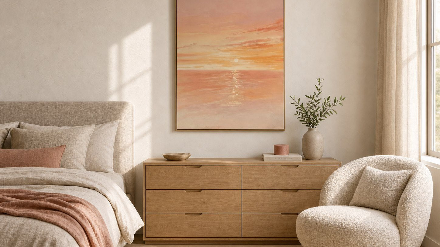 Coral sunset ocean wall art in a calm warm neutral bedroom
