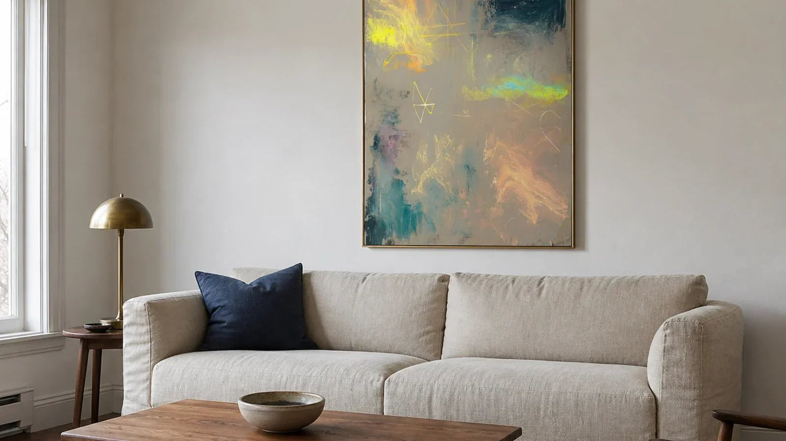 Hand-painted colorful abstract wall art with yellow and teal accents in a softly lit north-facing living room