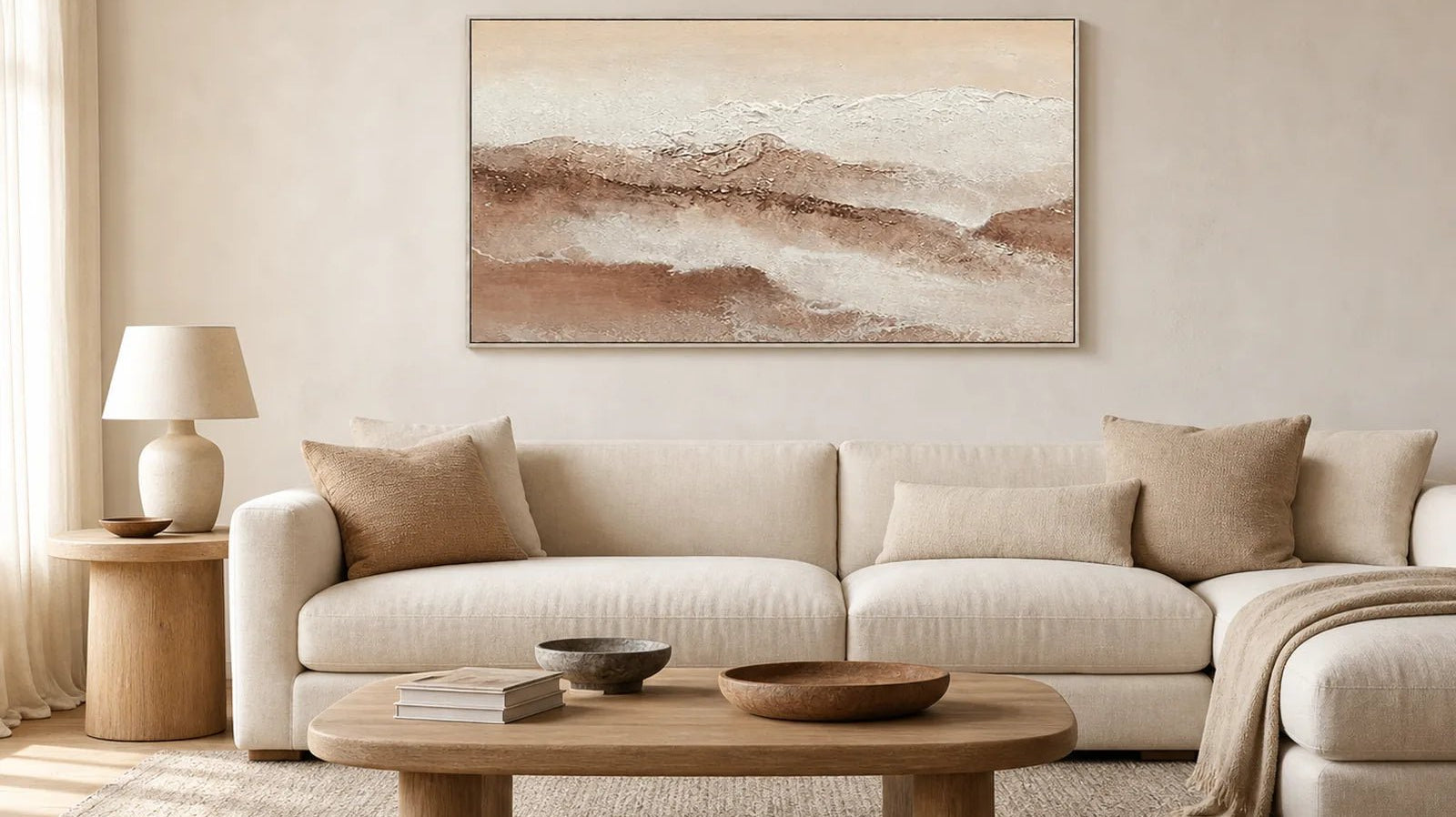 Neutral panoramic landscape wall art above a warm modern living room sofa