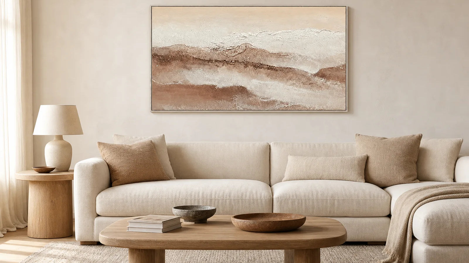 Neutral panoramic landscape wall art above a warm modern living room sofa