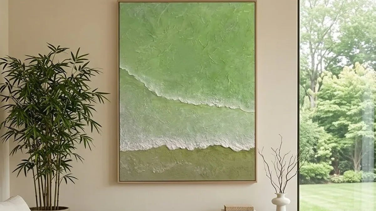 Large hand-painted sage green textured wall art in a sunlit neutral living room with garden views.
