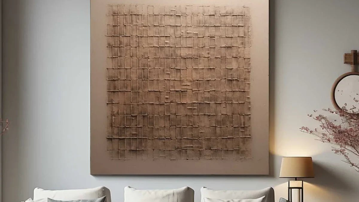 Beige and bronze Wabi-Sabi textured wall art displayed above a cream sofa in a neutral living room.