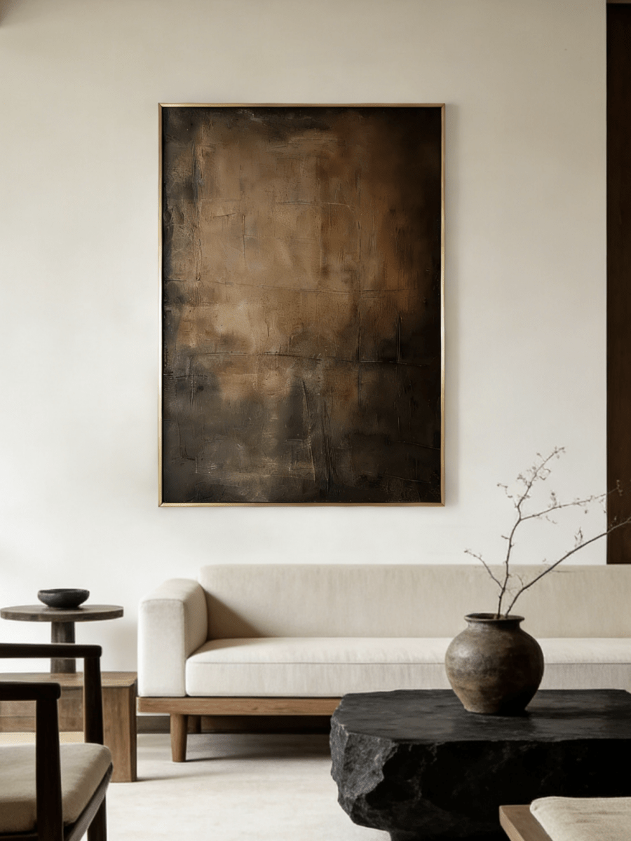 Close-up of vertical hand-painted 3D textured abstract painting with amber, brown, and charcoal impasto layers by Akari Kobayashi in a gold frame.