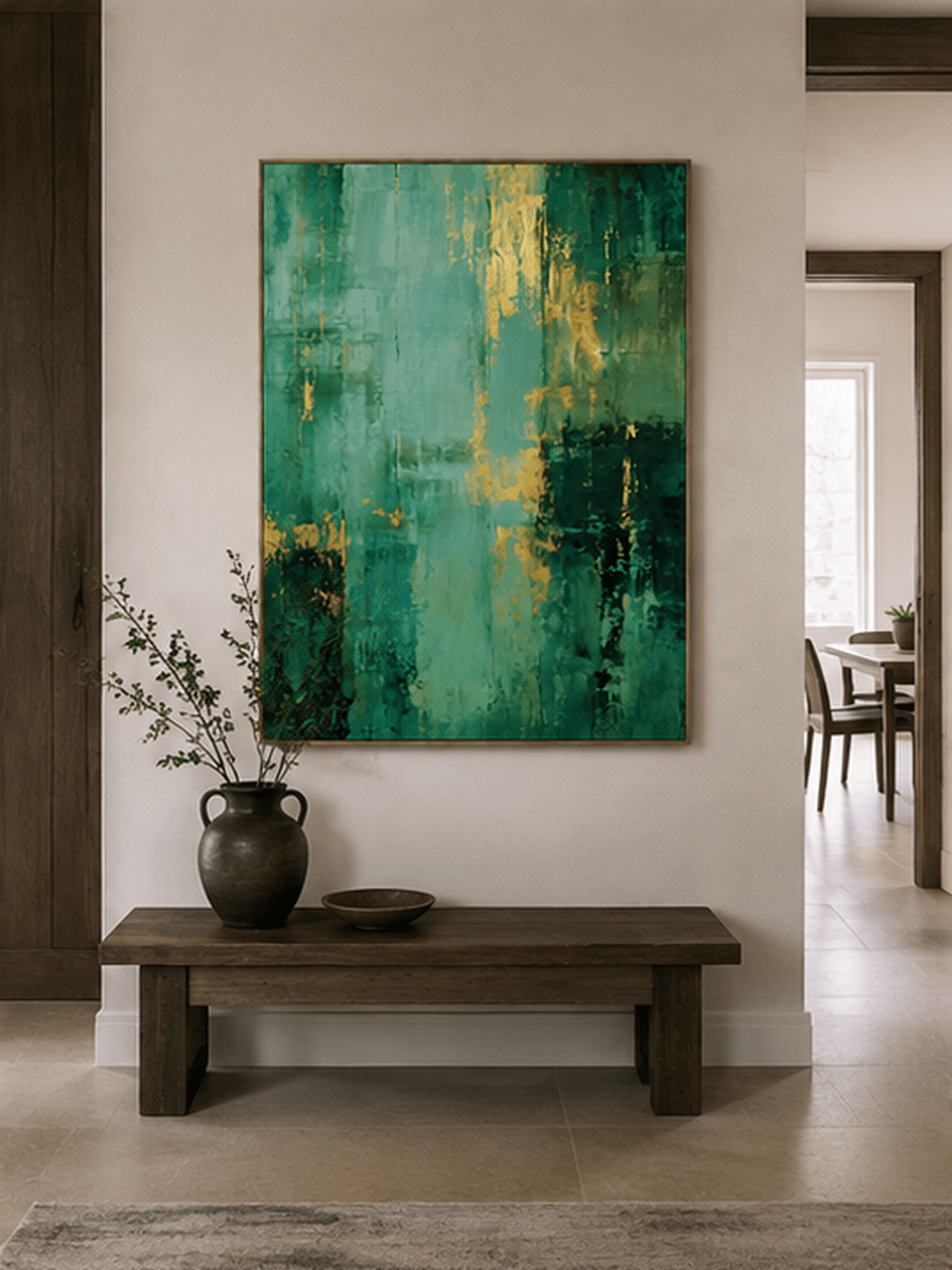 Vertical emerald green abstract painting displayed above a wood console in an organic modern entryway