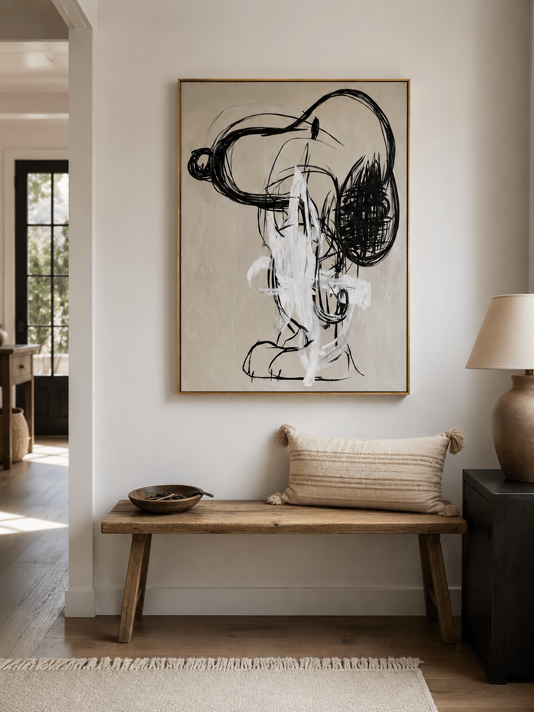 Abstract graffiti portrait displayed in a modern neutral living room