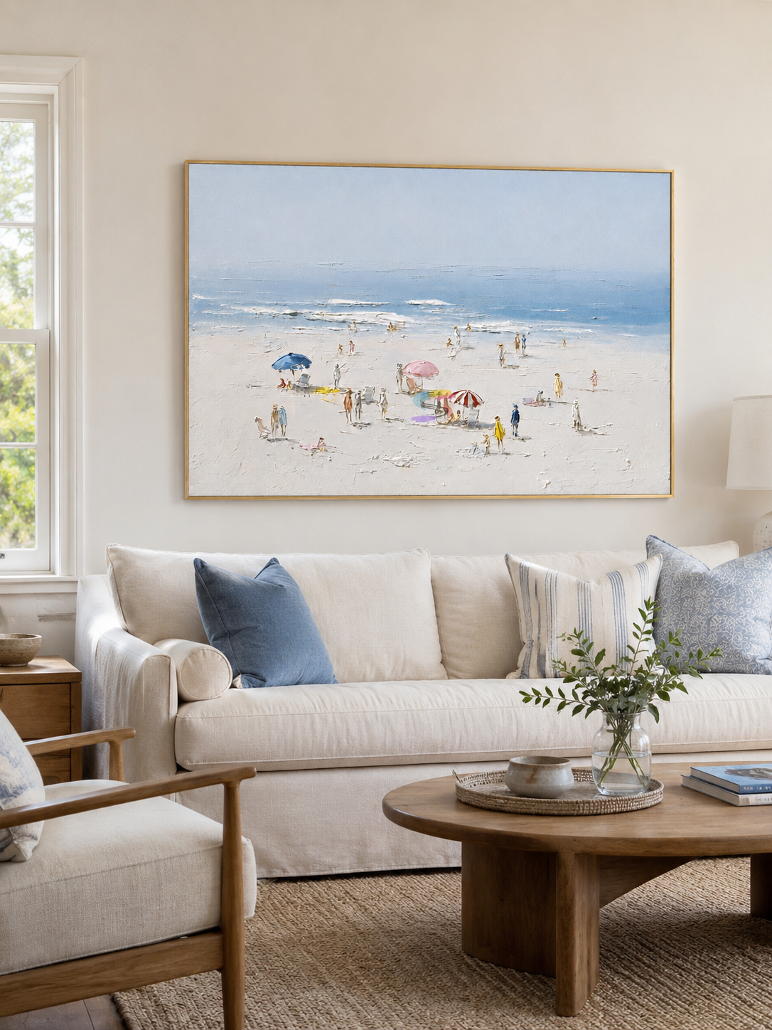 Beach scene wall art displayed above a light coastal living-room sofa