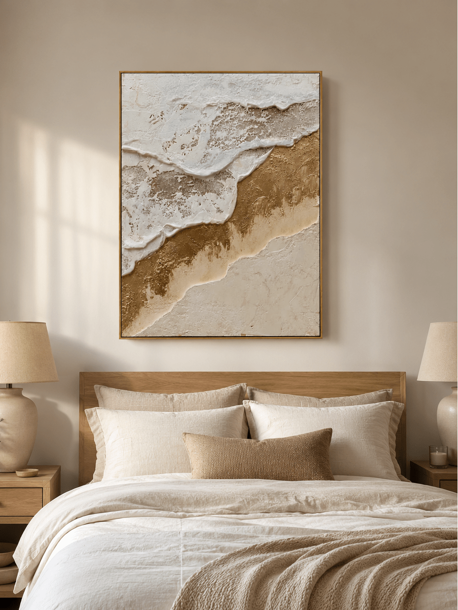 White and gold coastal wall art displayed above the bed in a modern neutral bedroom
