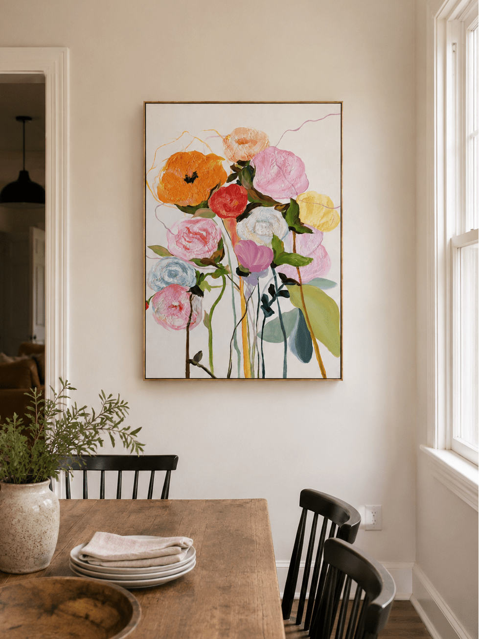 Colorful hand-painted floral wall art displayed in a modern open-plan dining room