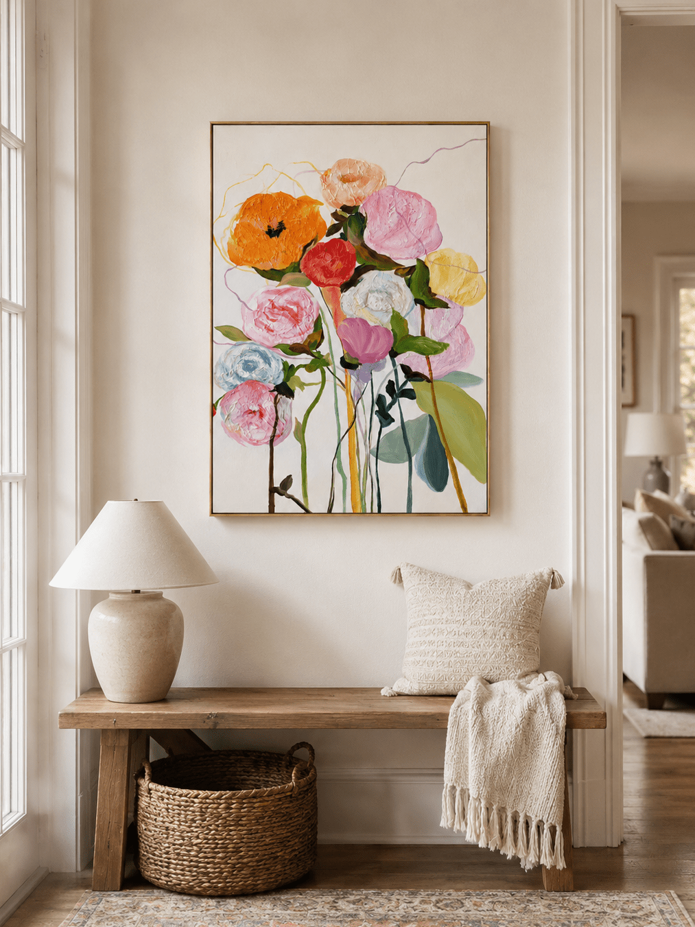 Vertical textured flower wall art displayed above a console table in a welcoming modern entryway