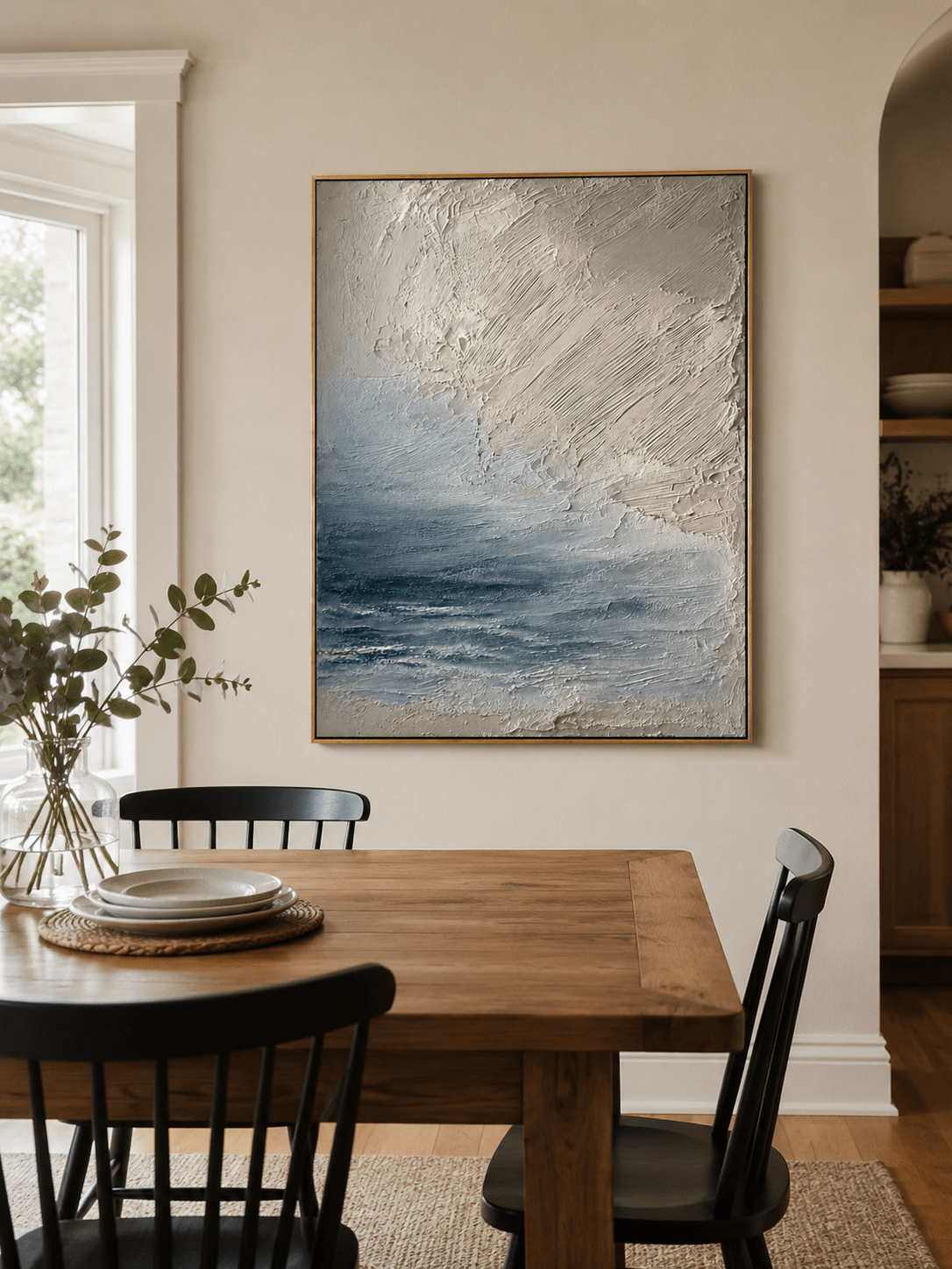 Hand-painted textured ocean wall art displayed in a modern open-plan dining room