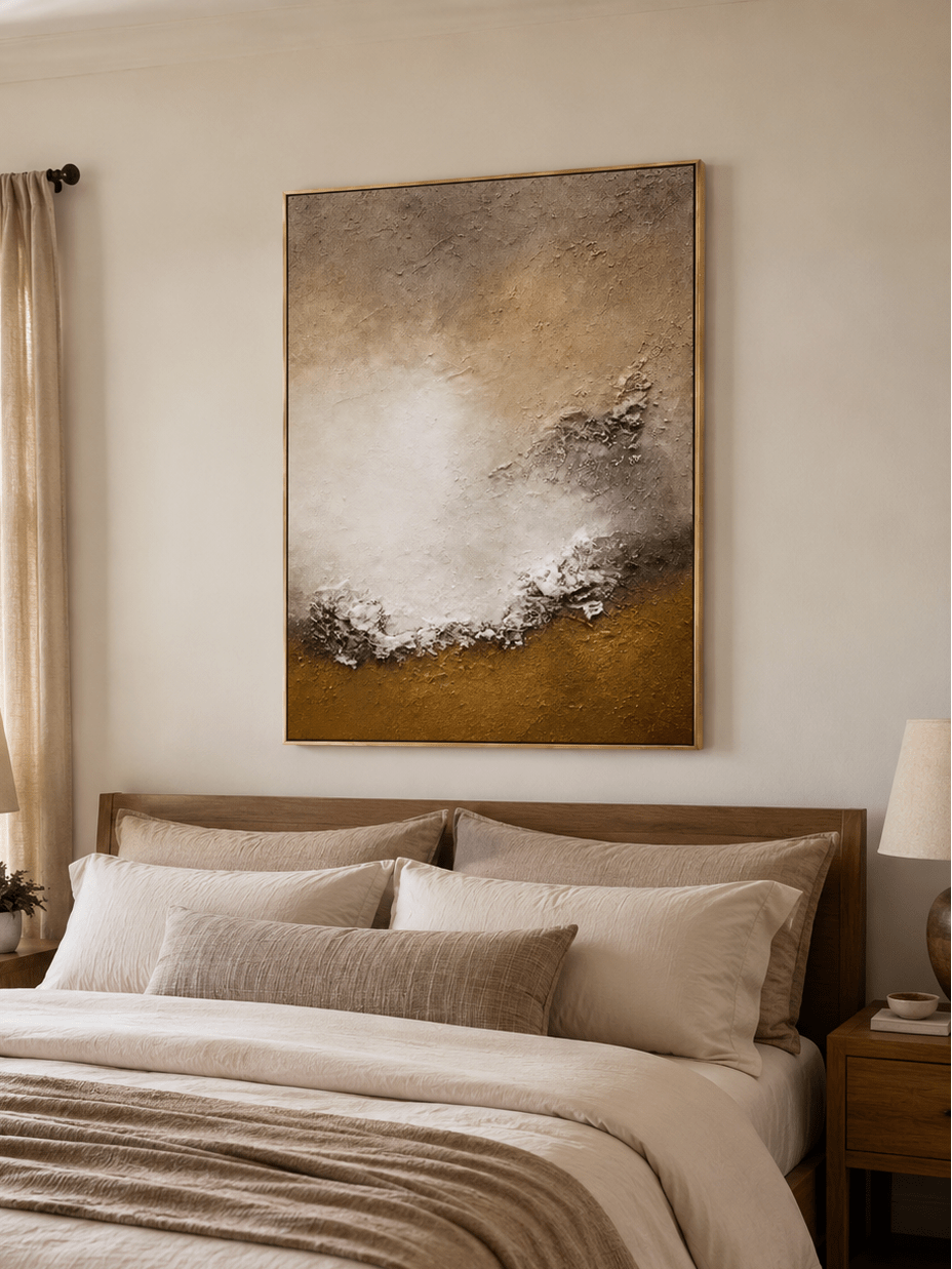Ivory and brown textured shoreline painting displayed above the bed in a warm neutral bedroom