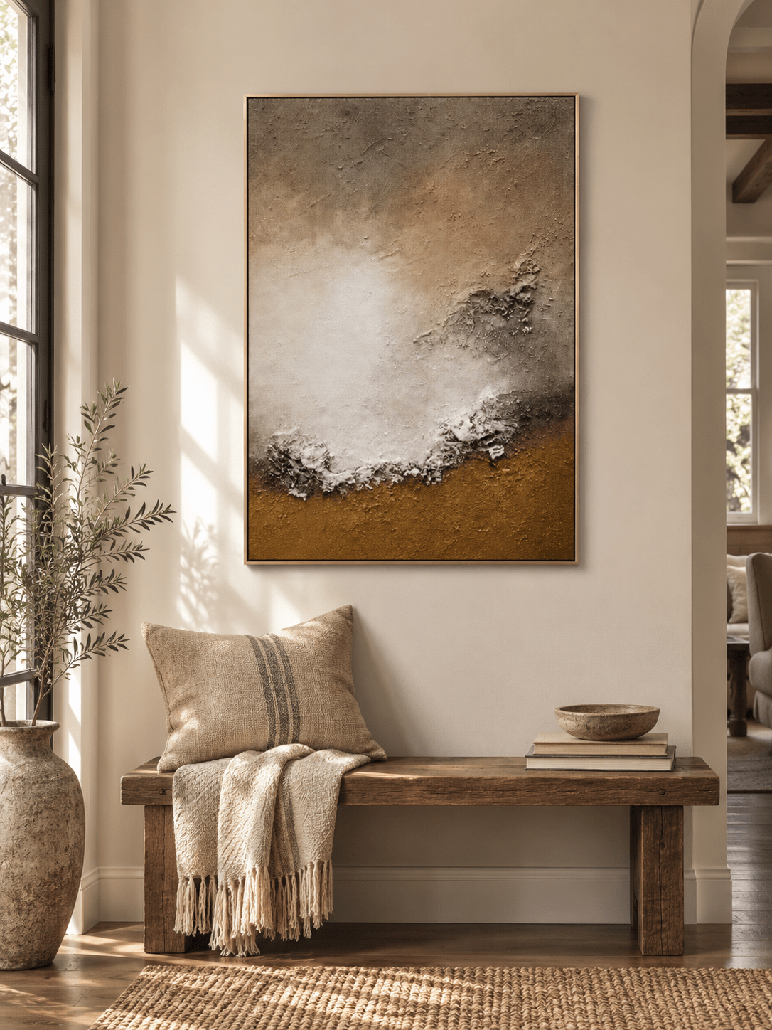 Vertical earth-tone shoreline wall art displayed above a console table in a contemporary entryway