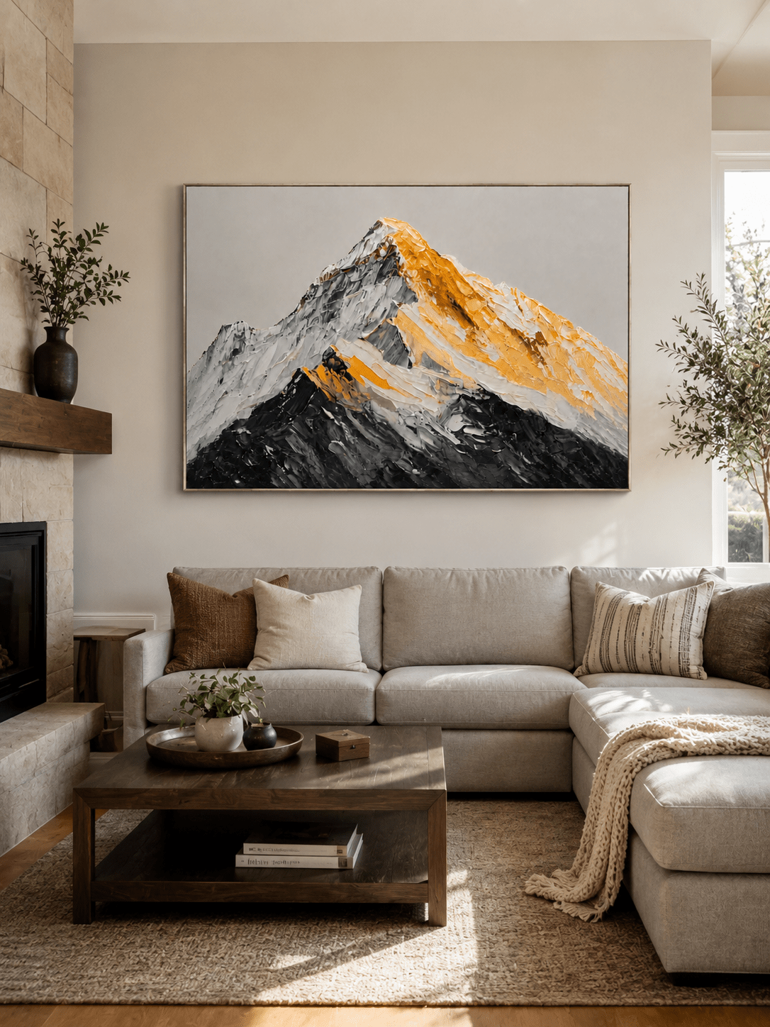 Black and gold textured mountain painting above a neutral sofa in a contemporary living room