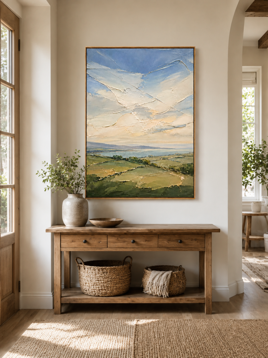 Sage green nature wall art above an entryway console in an organic modern foyer
