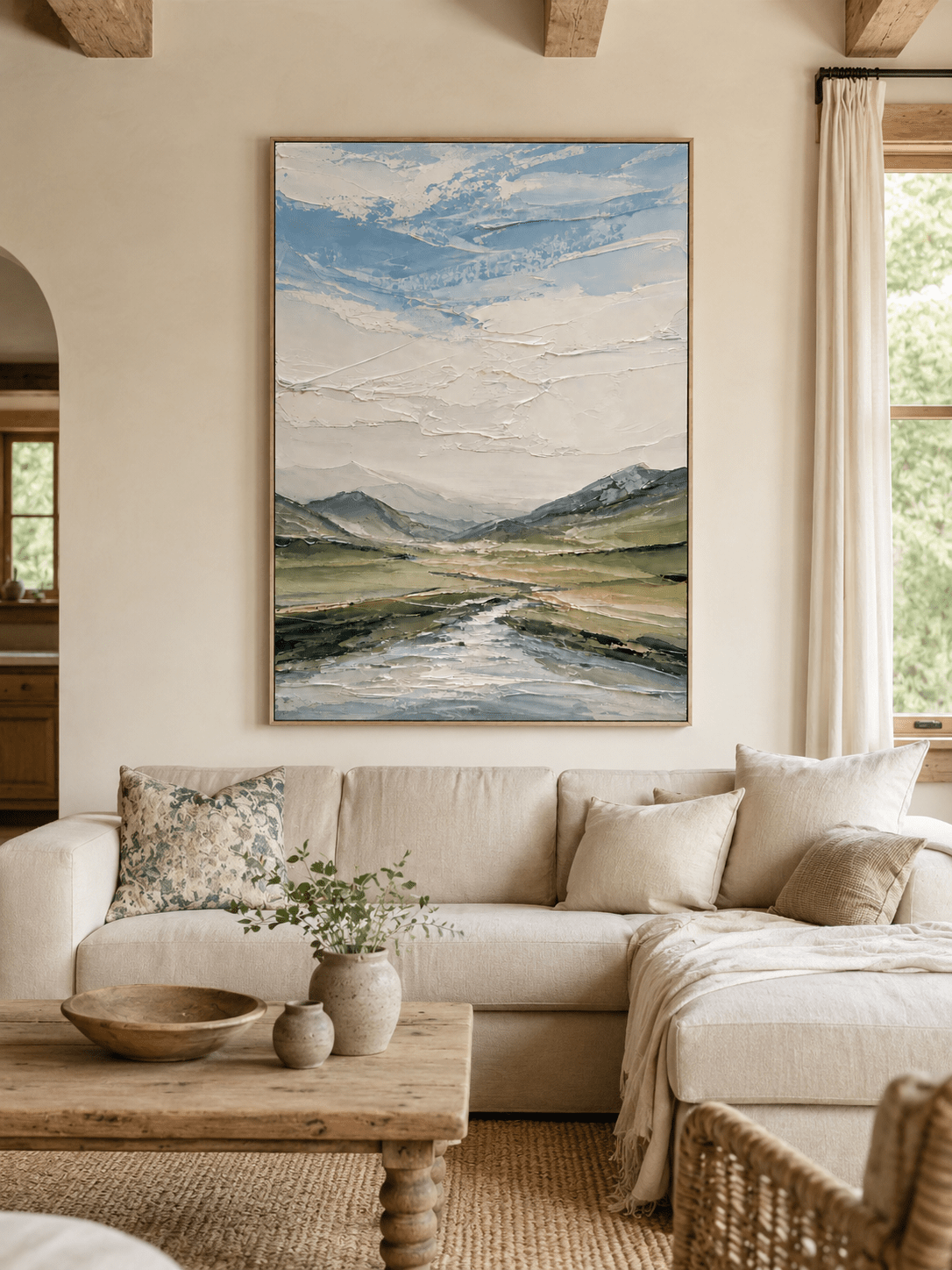 Modern textured mountain landscape painting by Evelyn Li displayed above a neutral sofa in a contemporary living room