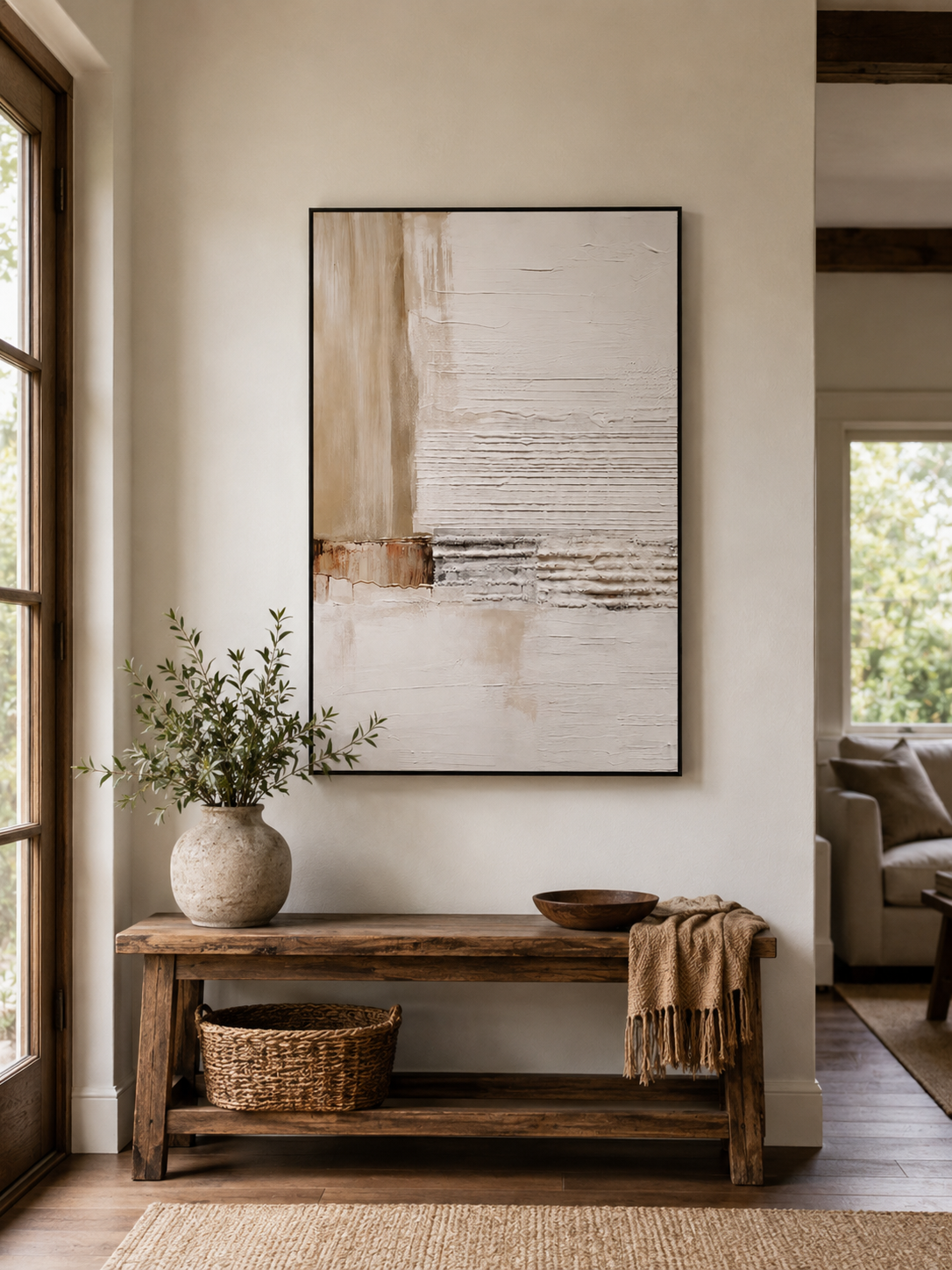 Organic modern neutral abstract painting displayed above a wood console in a minimalist entryway