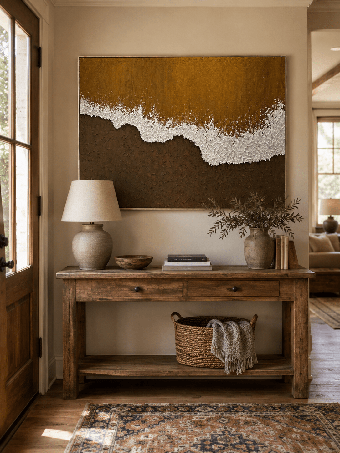 Wabi-Sabi brown coastal painting displayed above a wood console in an organic modern entryway