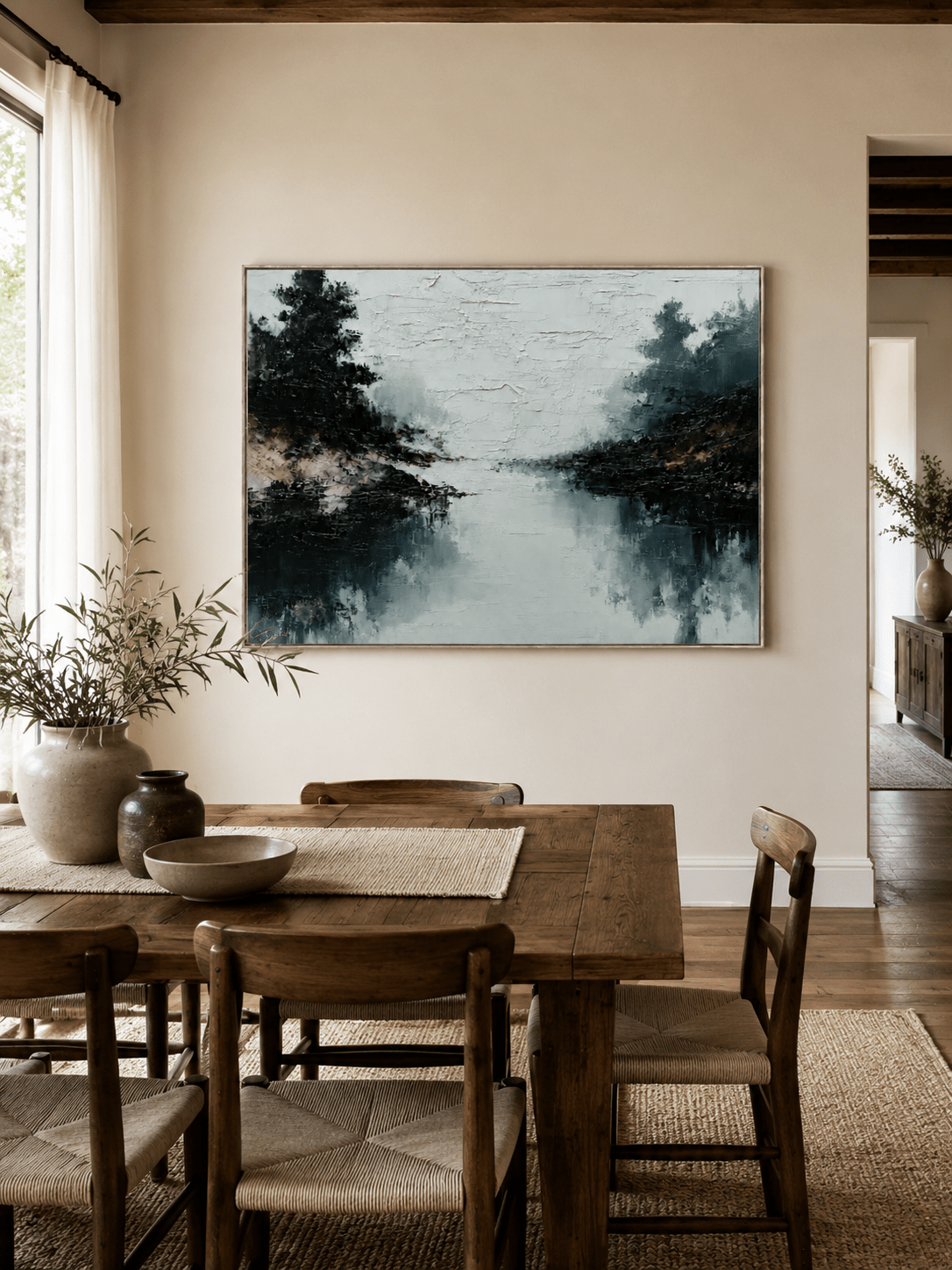 Hand-painted lake reflection landscape displayed in a dining room with natural wood furniture