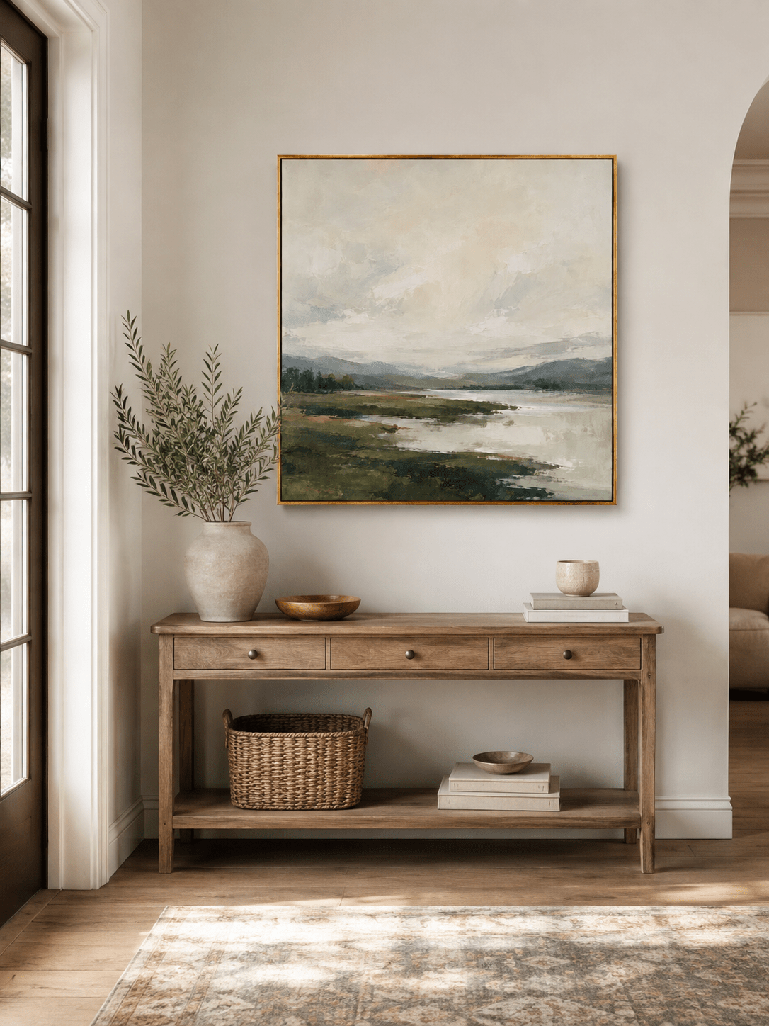 Neutral green textured landscape wall art displayed above an entryway console in a contemporary home