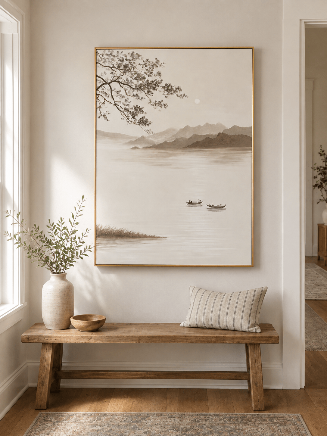 Minimalist lake landscape wall art above an entryway console in a neutral Japandi foyer