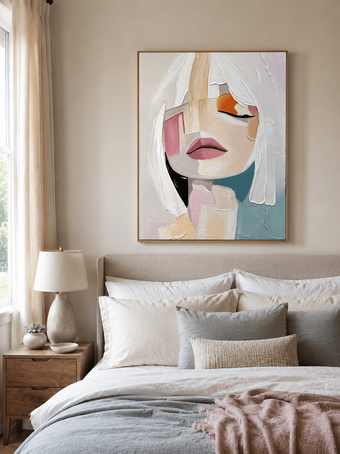 Textured woman portrait wall art displayed above a bed in a warm contemporary bedroom