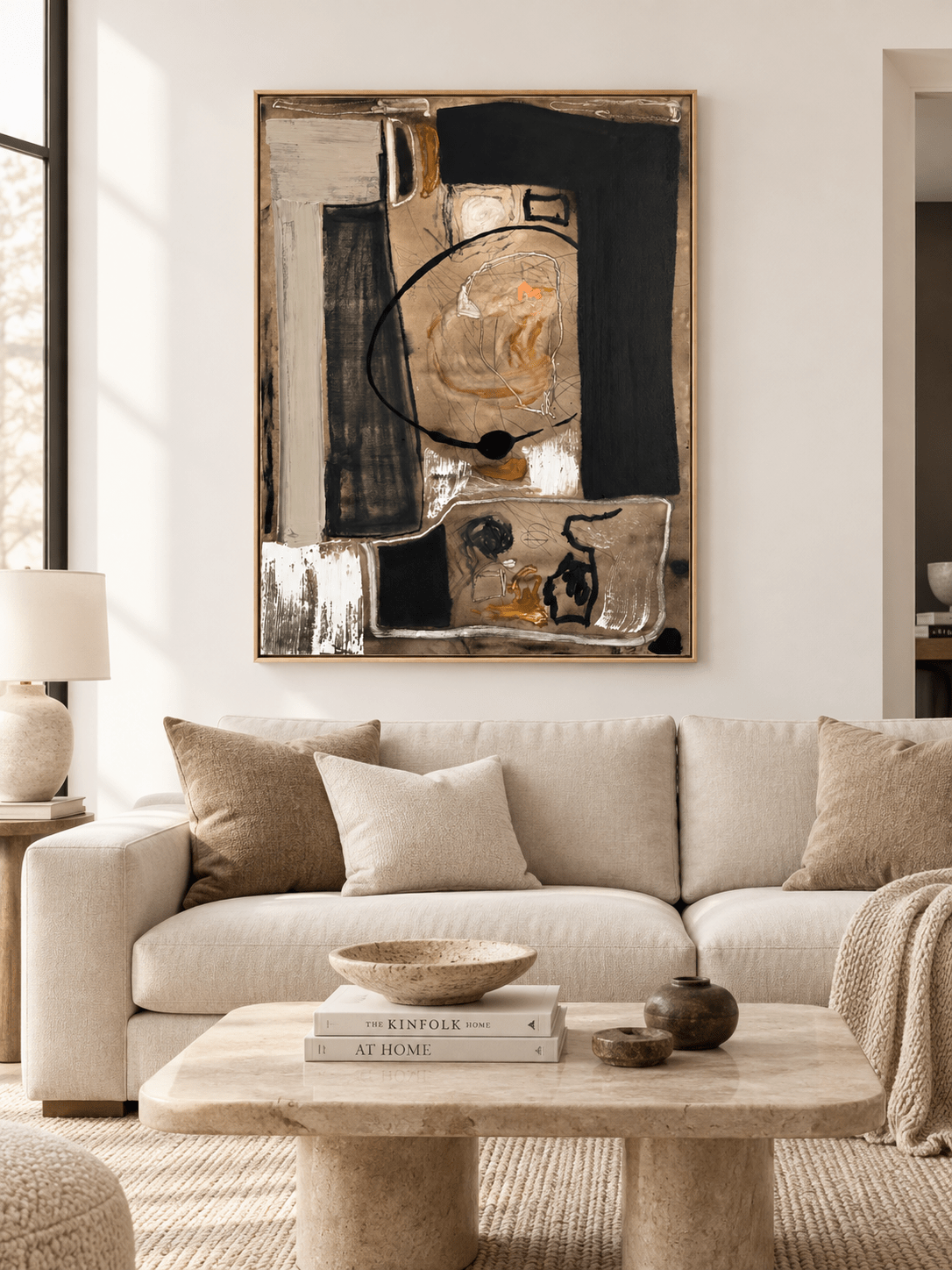 Large black and beige abstract wall art displayed above a sofa in a contemporary living room