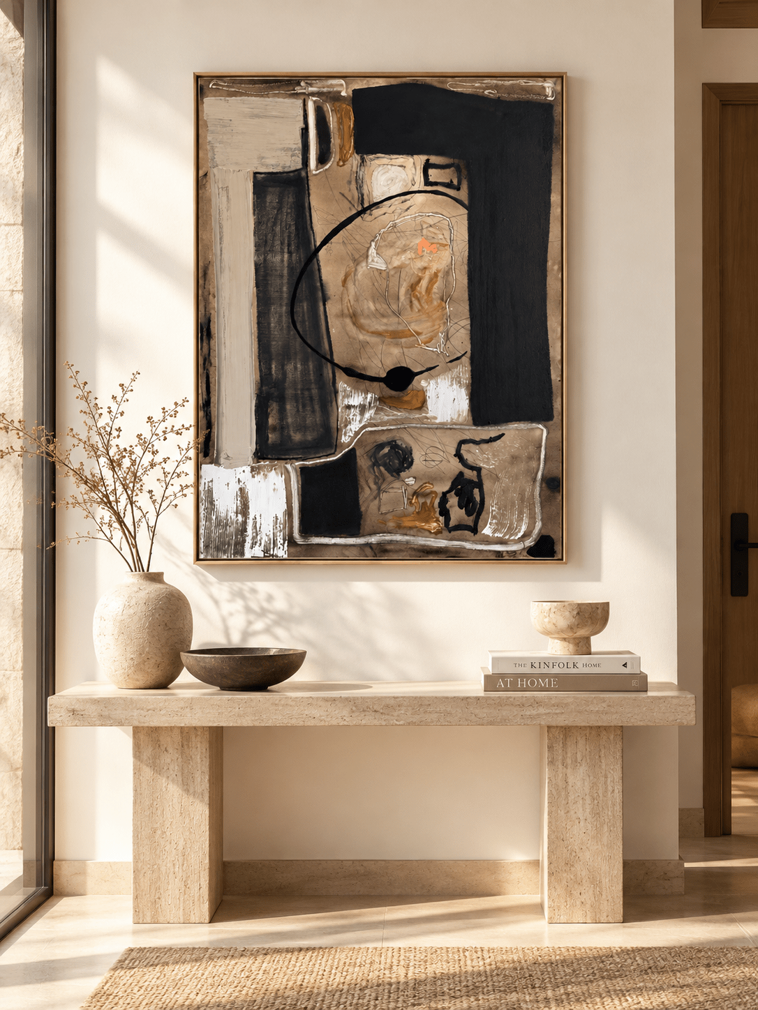 Vertical black and beige gestural abstract painting displayed above a console in a contemporary entryway