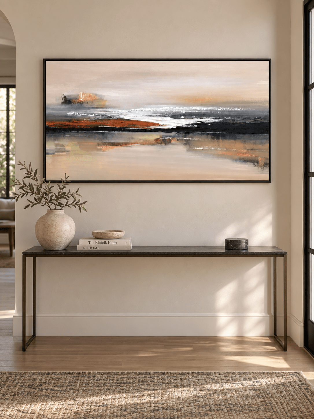 Large horizontal earth-tone abstract painting displayed above a long console in a contemporary entryway