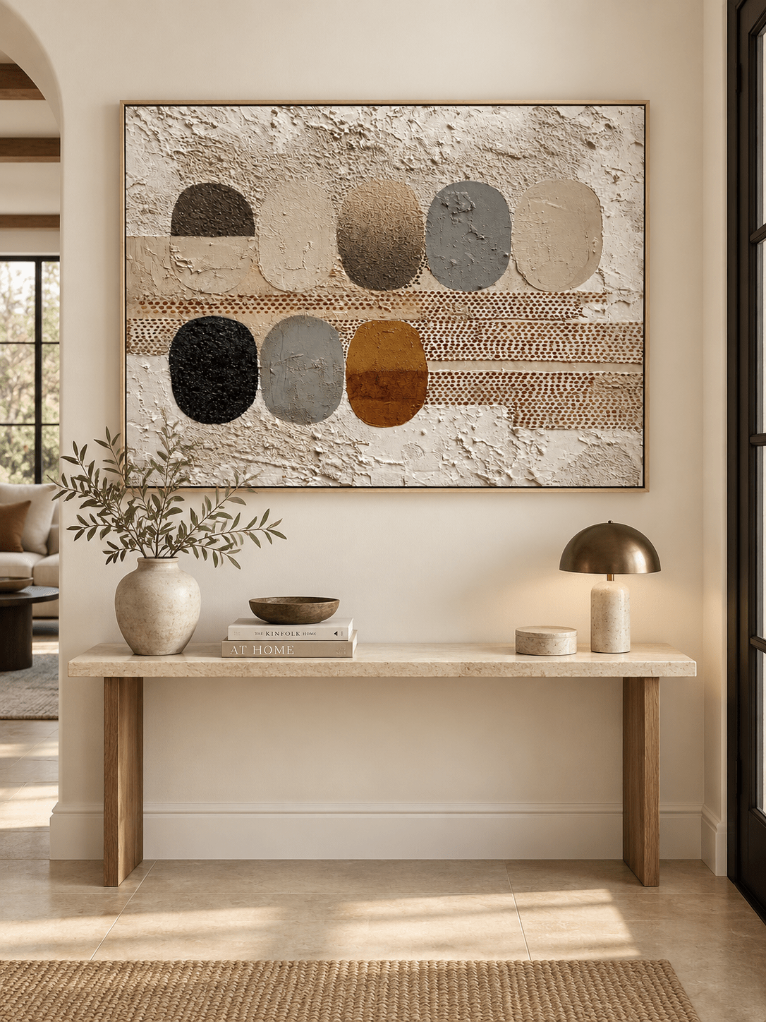 Horizontal textured earth tone abstract painting displayed above a console in a contemporary entryway