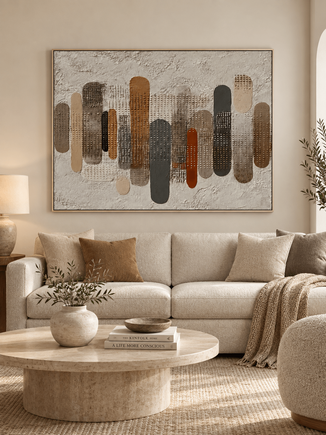 Large earth-tone textured geometric wall art displayed above a sofa in a modern organic living room