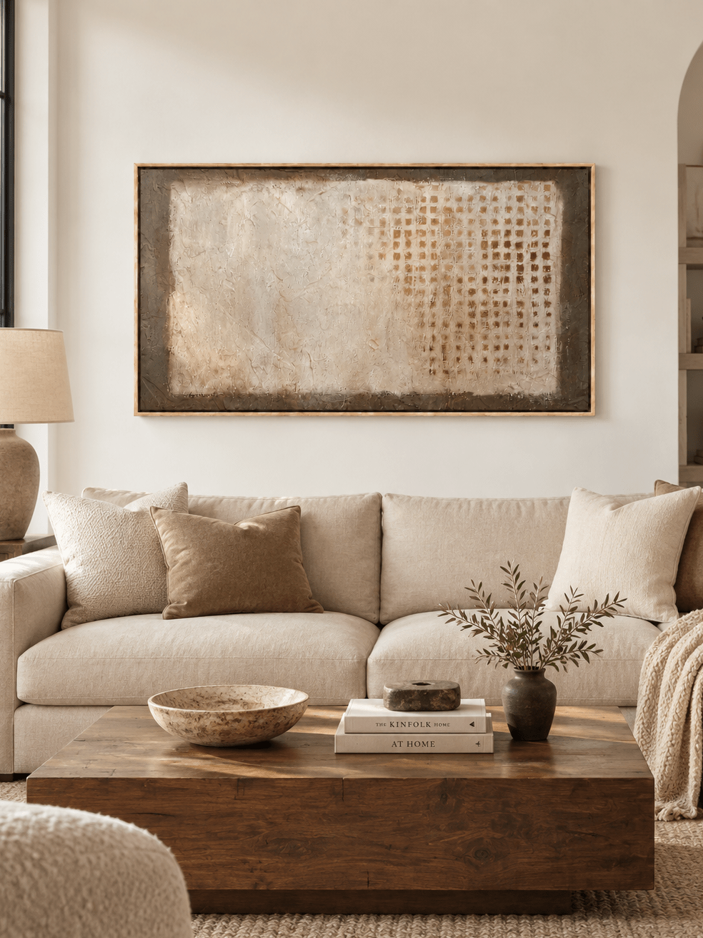 Large neutral textured abstract wall art displayed above a cream sofa in a modern organic living room