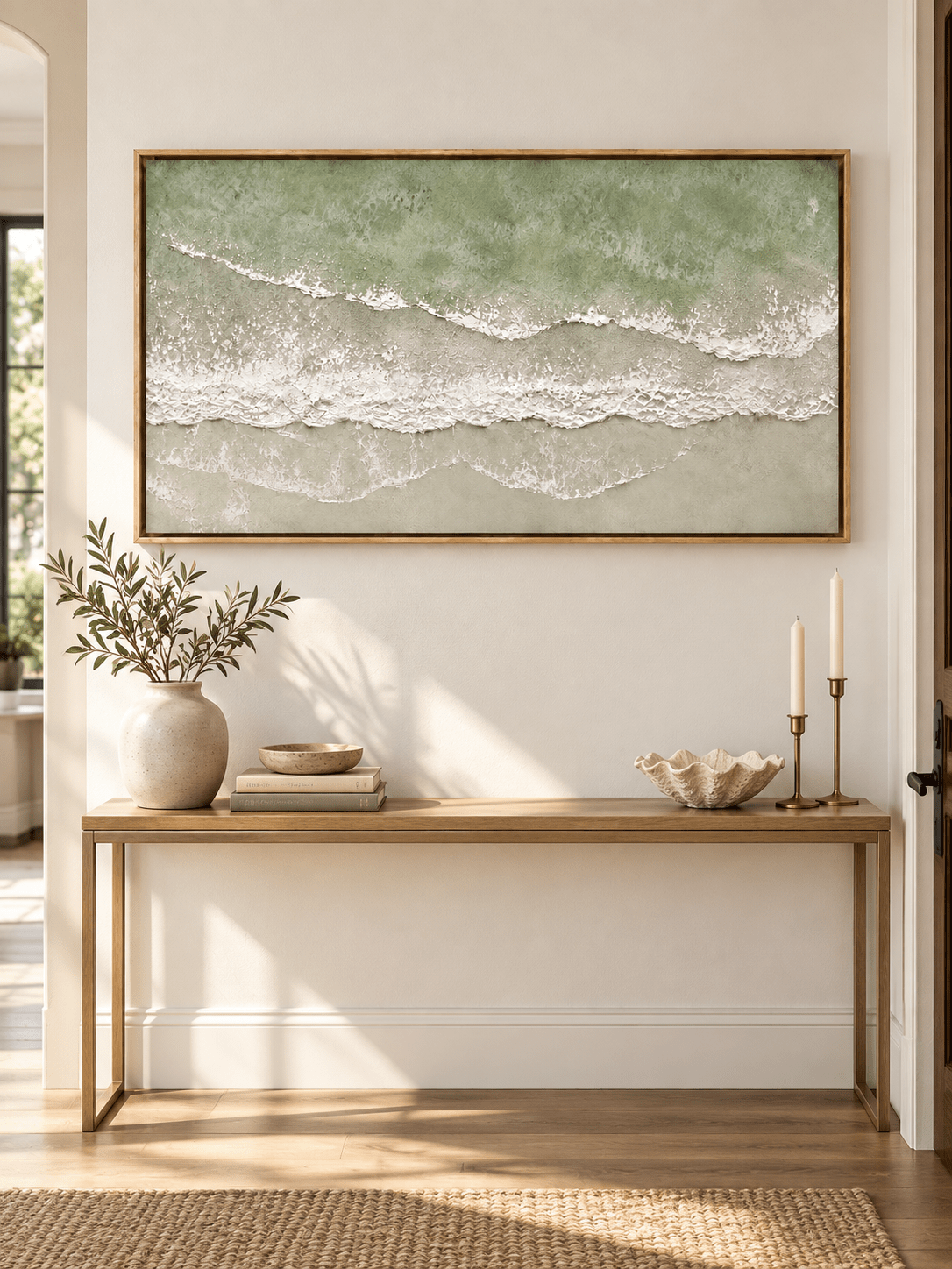 Horizontal seafoam green ocean wave painting displayed above a console in a modern coastal entryway