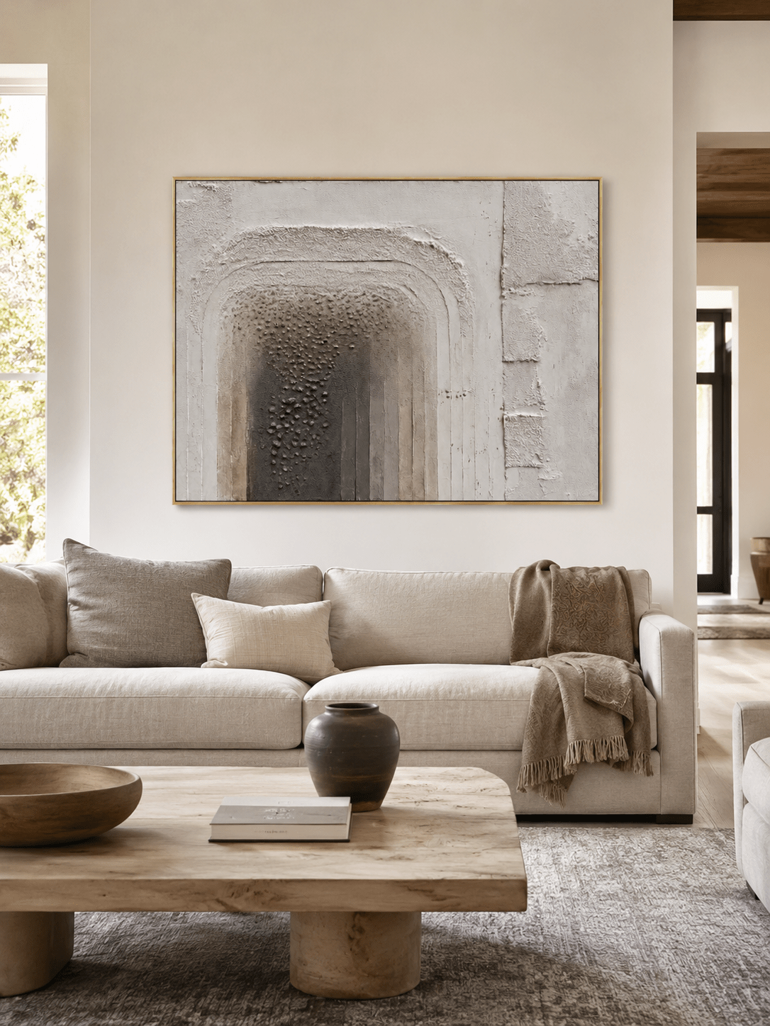 Horizontal wabi-sabi wall art displayed above a neutral living-room sofa