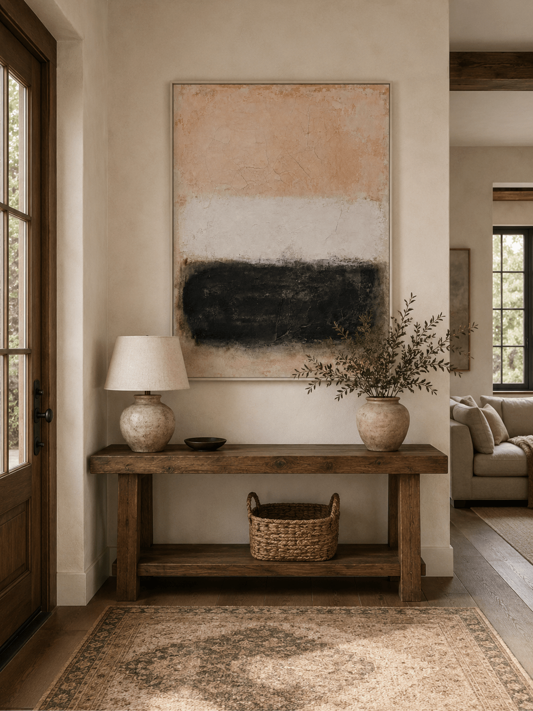 Wabi-Sabi beige and black abstract painting displayed above a wood console in a neutral entryway