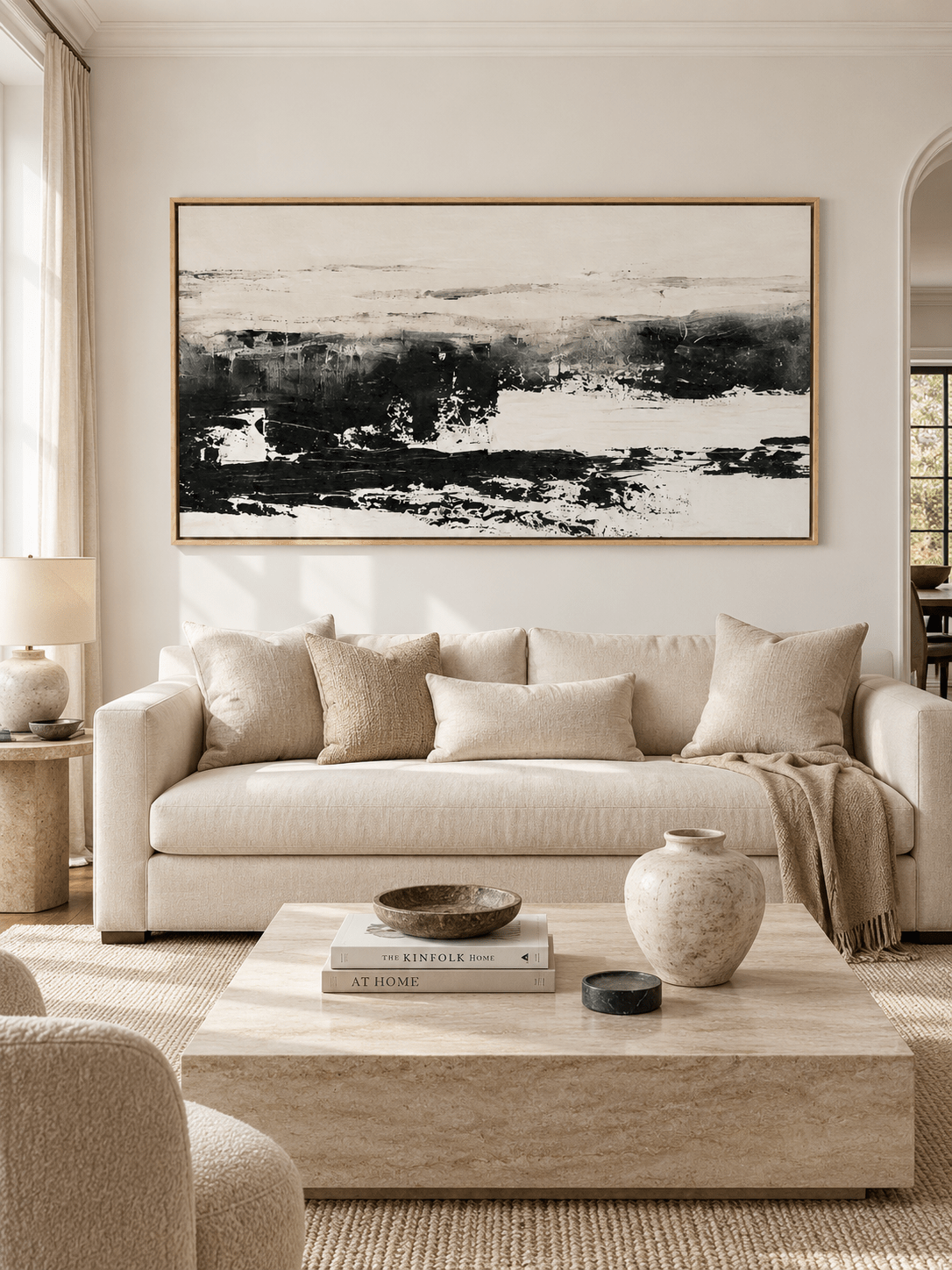 Large black and white abstract landscape wall art displayed above a sofa in a contemporary living room