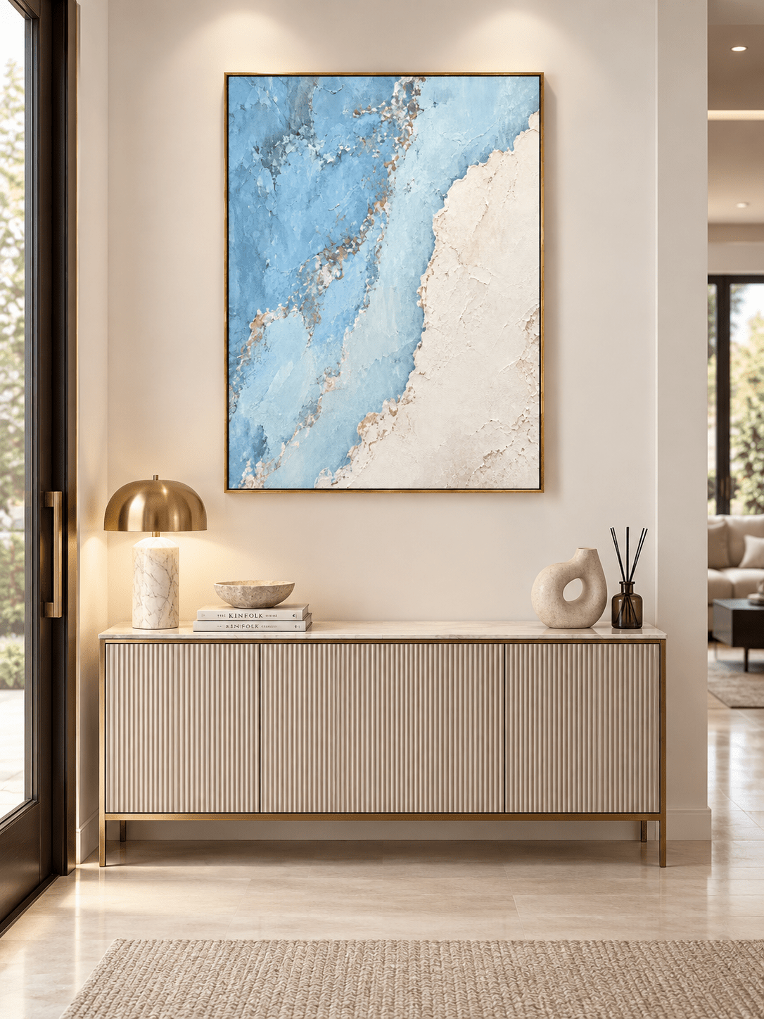 Vertical blue and ivory textured abstract painting displayed above a console in a modern coastal entryway