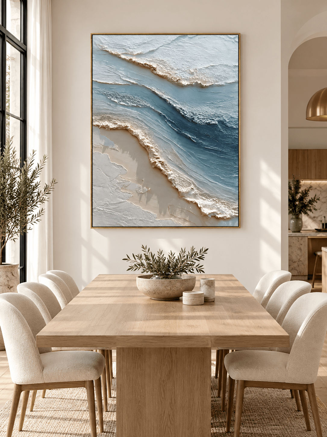 Hand-painted ocean surf wall art with raised white wave texture displayed in a modern open-plan dining room