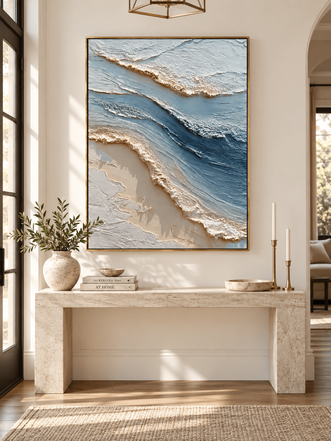 Vertical textured seascape painting in ocean blue and ivory displayed above a console in a coastal entryway