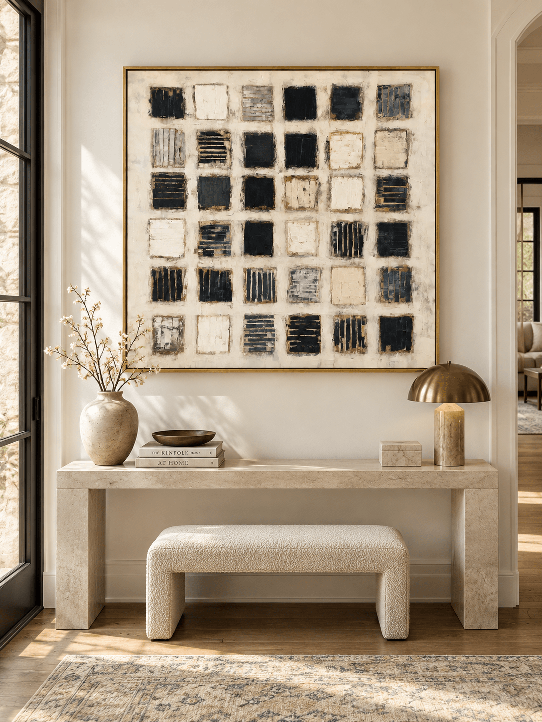 Horizontal black and white textured abstract painting displayed above a console in a modern entryway