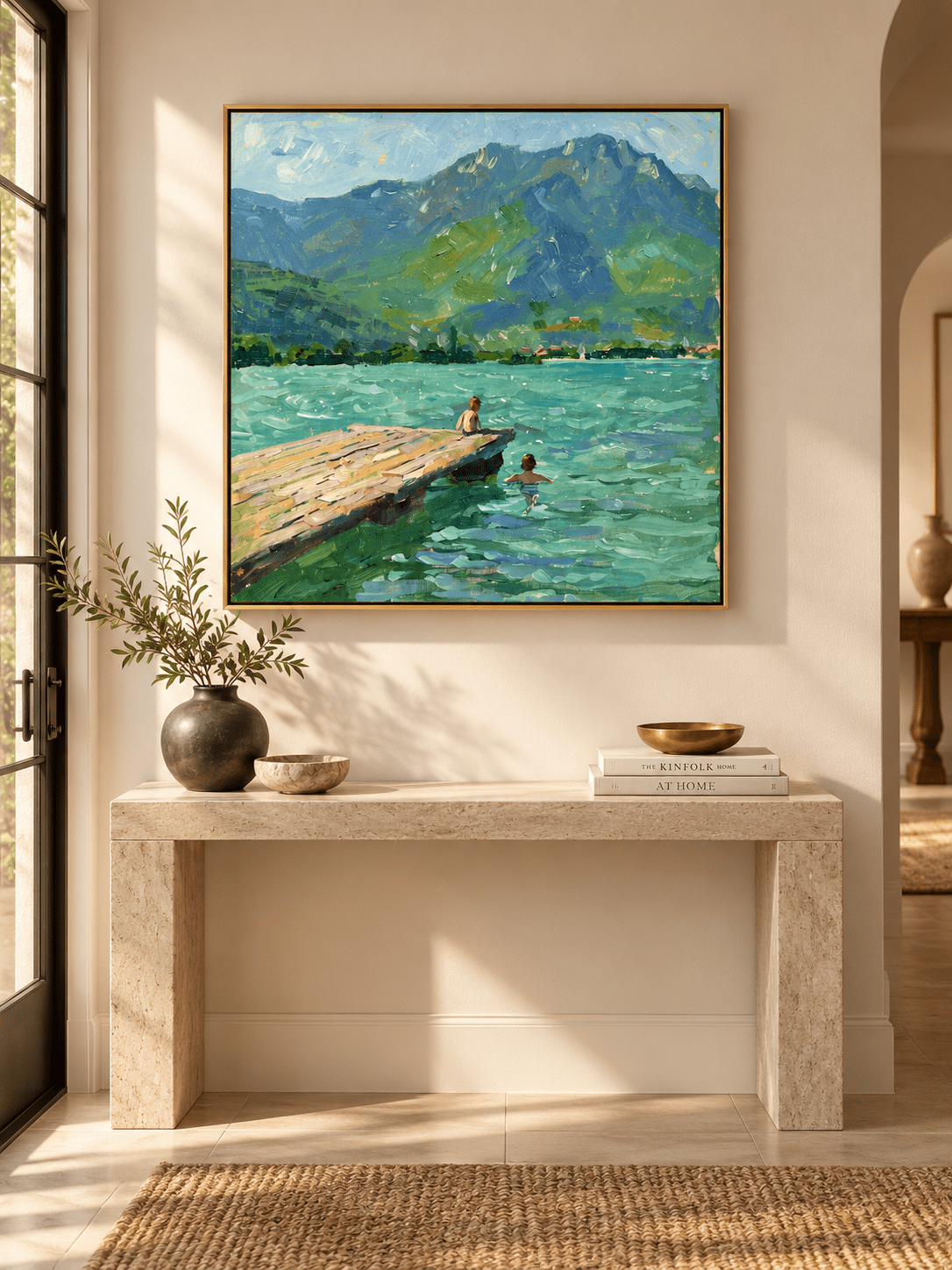 Square turquoise lake landscape painting with green mountains and a wooden dock displayed above an entryway console