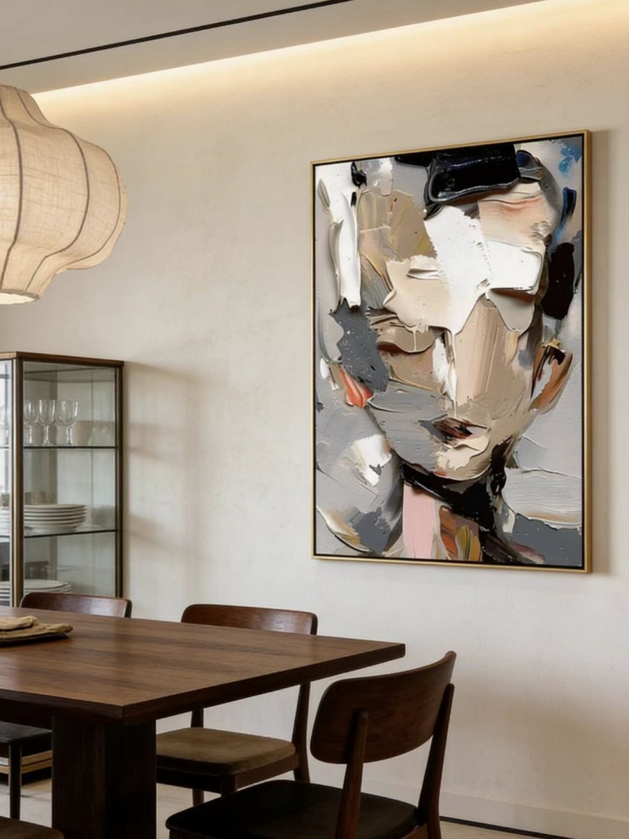 A high-definition close-up of a hand-painted abstract portrait , showing extremely thick impasto paint texture in grey, cream, and orange.