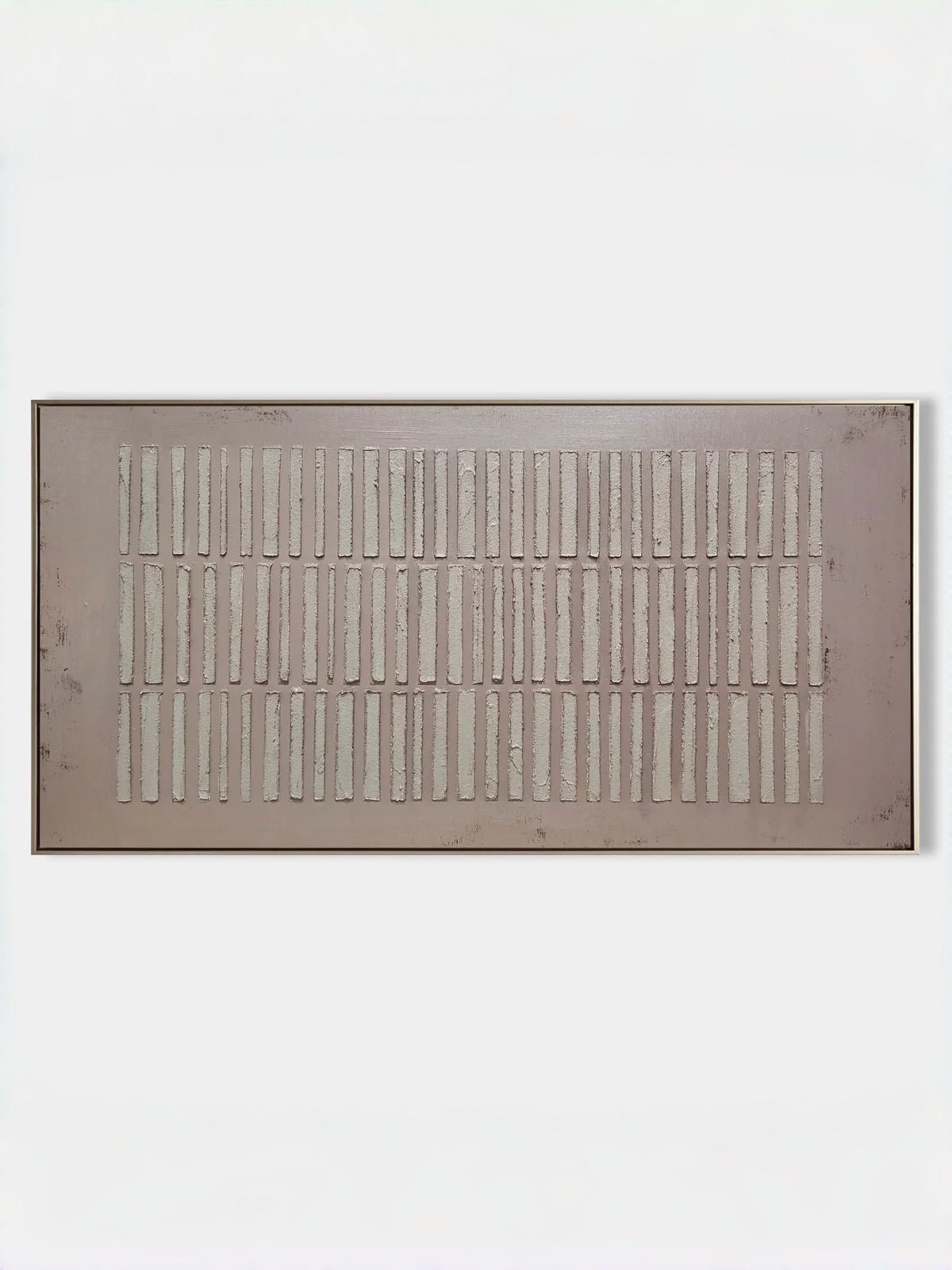 A large horizontal modern 3D relief painting by Eliot Vermeer featuring repeating vertical textured bars in white over a warm taupe background, hung above a minimalist sofa.