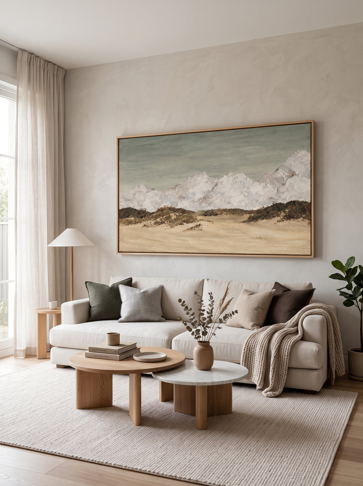 Textured Wabi-Sabi mountain landscape painting displayed above a sofa in a warm neutral modern living room.