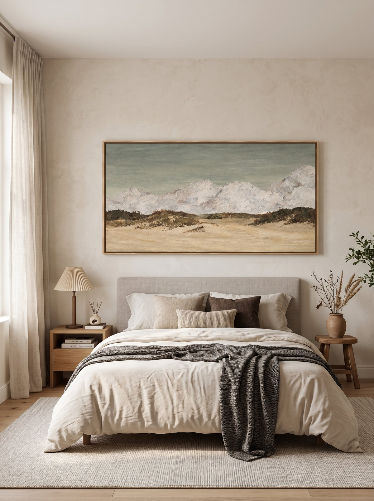 Snowy mountain wall art in sage gray, beige and ivory tones displayed above a bed in a calm modern bedroom.