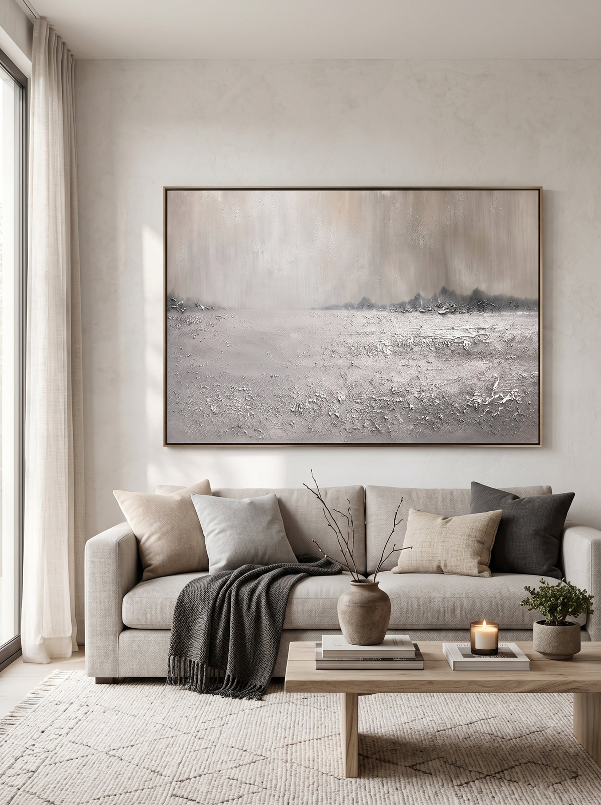 Large horizontal neutral winter landscape canvas wall art above modern sofa in minimalist living room