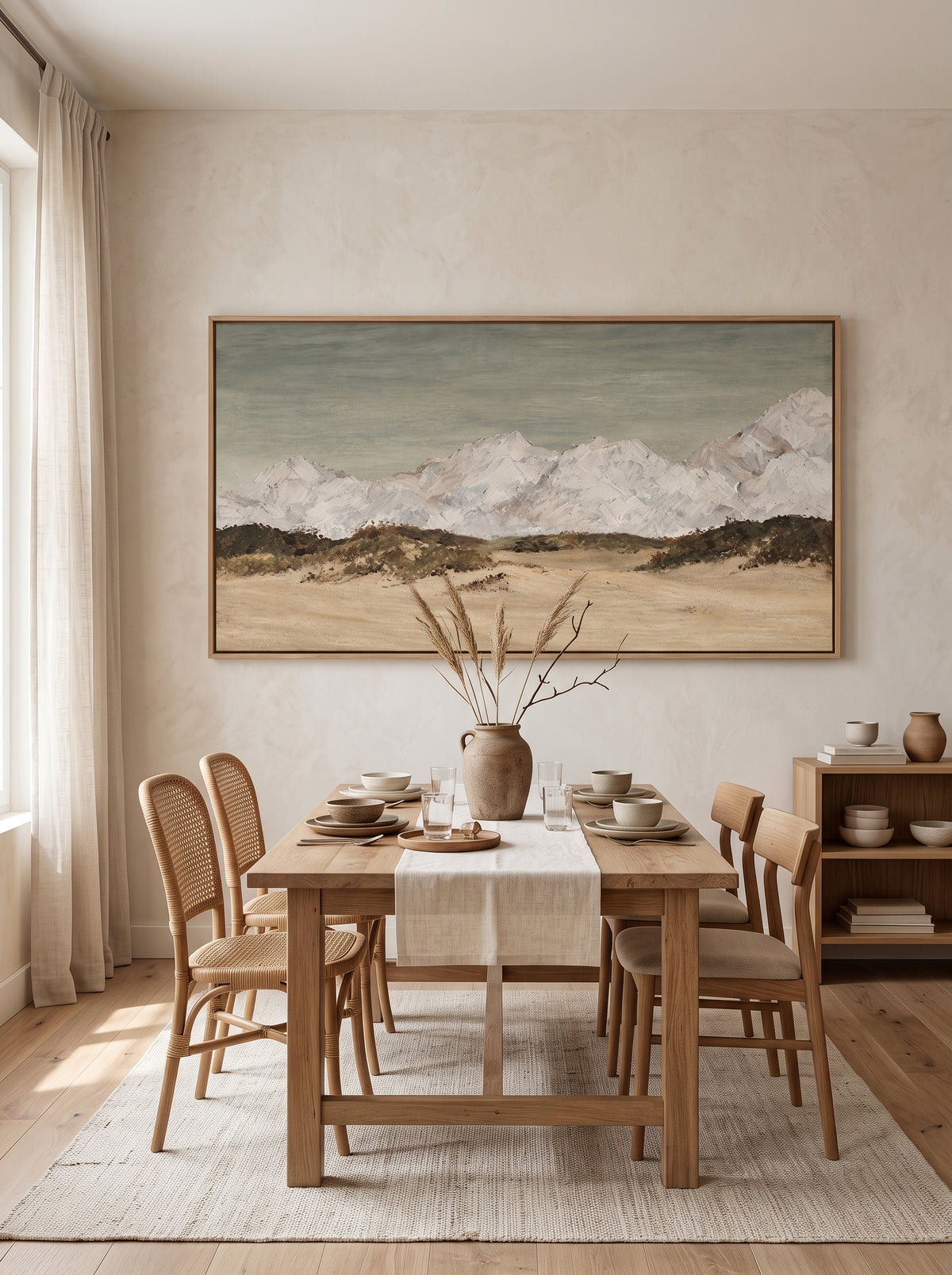 Hand-painted neutral mountain landscape displayed in an open dining room with natural wood and modern organic decor.