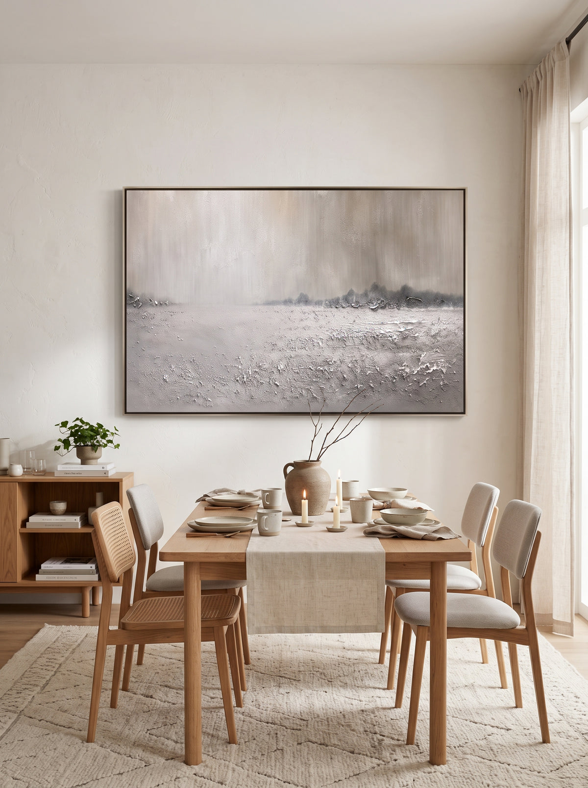 Framed textured off-white winter landscape painting displayed in modern open-concept dining room