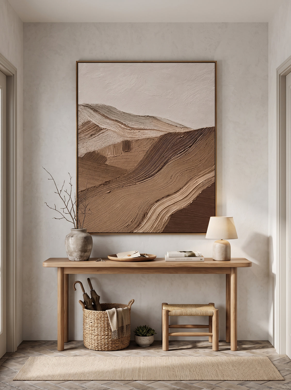 Sculptural earthy brown wave relief canvas painting hung above minimalist console table in Japandi foyer